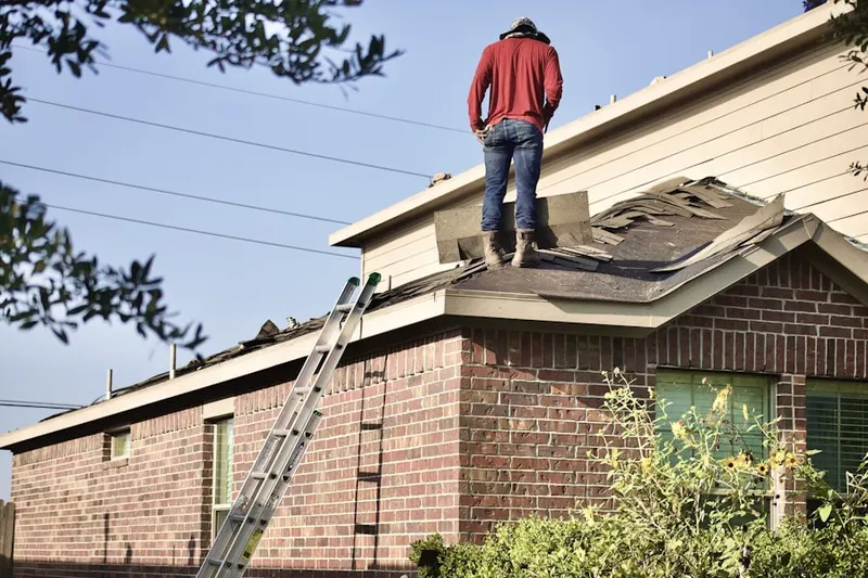 Professional roofer working on a residential roof in Little Managua